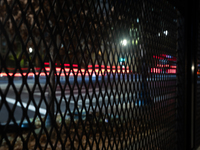 Cars pass by anti-riot fencing installed for the presidential election around the White House and Lafayette Park in Washington, DC, on Novem...