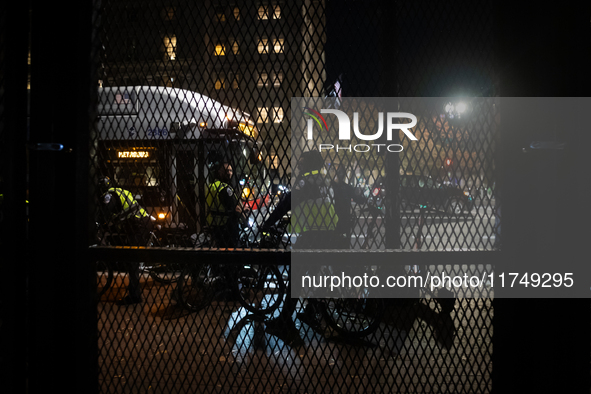 DC police and a city bus are seen outside the anti-riot fencing installed around the White House and Lafayette Park for the election in Wash...