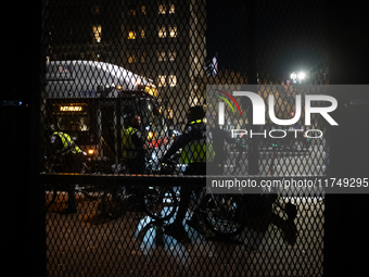 DC police and a city bus are seen outside the anti-riot fencing installed around the White House and Lafayette Park for the election in Wash...