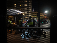 DC police and a city bus are seen outside the anti-riot fencing installed around the White House and Lafayette Park for the election in Wash...