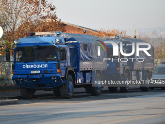 Police vehicles park outside the venue on the day of the 5th European Political Community Summit in Budapest, Hungary, on November 7, a day...