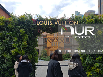 Pedestrians pass by Louis Vuitton's world's first home goods store in Shanghai, China, on November 7, 2024. (