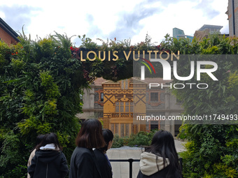 Pedestrians pass by Louis Vuitton's world's first home goods store in Shanghai, China, on November 7, 2024. (