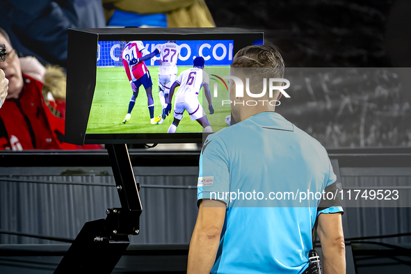 Referee Aleksandr Radius checks VAR during the match between Feyenoord and Salzburg at the Feyenoord stadium De Kuip for the UEFA Champions...