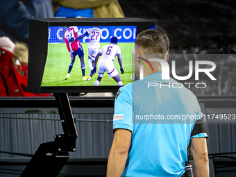 Referee Aleksandr Radius checks VAR during the match between Feyenoord and Salzburg at the Feyenoord stadium De Kuip for the UEFA Champions...