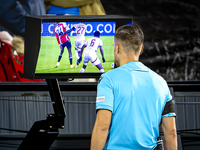 Referee Aleksandr Radius checks VAR during the match between Feyenoord and Salzburg at the Feyenoord stadium De Kuip for the UEFA Champions...