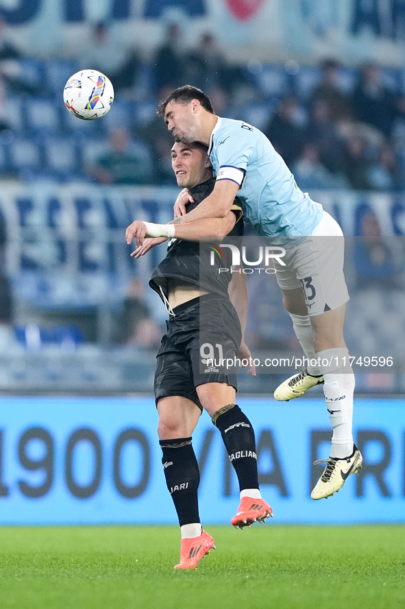 Roberto Piccoli of Cagliari Calcio and Alessio Romagnoli of SS Lazio jump for the ball during the Serie A Enilive match between SS Lazio and...