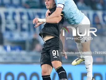 Roberto Piccoli of Cagliari Calcio and Alessio Romagnoli of SS Lazio jump for the ball during the Serie A Enilive match between SS Lazio and...