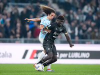 Luca Pellegrini of SS Lazio and Michel Ndary Adopo of Cagliari Calcio compete for the ball during the Serie A Enilive match between SS Lazio...