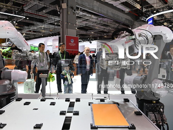 Visitors visit the NACHI exhibition area during the technical equipment exhibition area of the 7th China International Import Expo in Shangh...