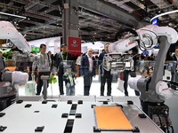 Visitors visit the NACHI exhibition area during the technical equipment exhibition area of the 7th China International Import Expo in Shangh...