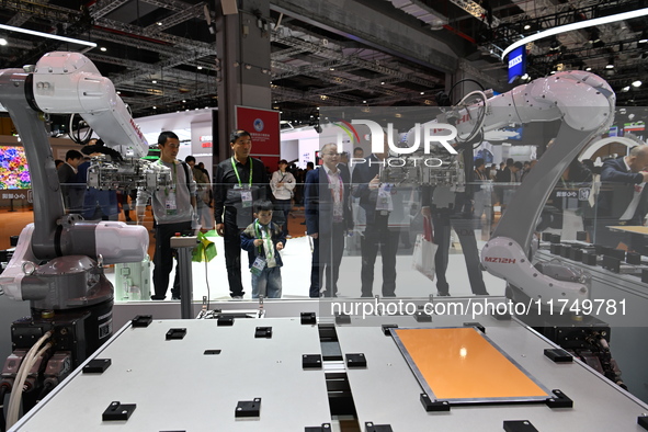 Visitors visit the NACHI exhibition area during the technical equipment exhibition area of the 7th China International Import Expo in Shangh...