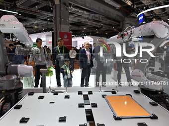 Visitors visit the NACHI exhibition area during the technical equipment exhibition area of the 7th China International Import Expo in Shangh...