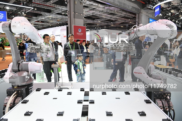 Visitors visit the NACHI exhibition area during the technical equipment exhibition area of the 7th China International Import Expo in Shangh...