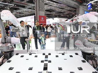 Visitors visit the NACHI exhibition area during the technical equipment exhibition area of the 7th China International Import Expo in Shangh...