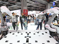 Visitors visit the NACHI exhibition area during the technical equipment exhibition area of the 7th China International Import Expo in Shangh...