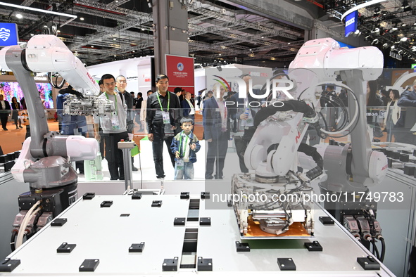 Visitors visit the NACHI exhibition area during the technical equipment exhibition area of the 7th China International Import Expo in Shangh...