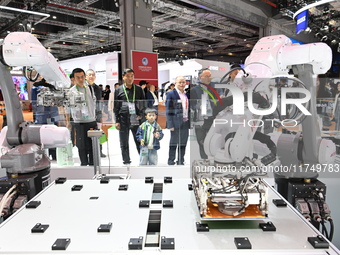 Visitors visit the NACHI exhibition area during the technical equipment exhibition area of the 7th China International Import Expo in Shangh...