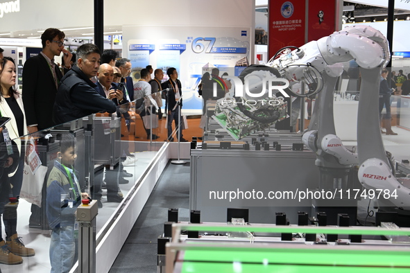 Visitors visit the NACHI exhibition area during the technical equipment exhibition area of the 7th China International Import Expo in Shangh...