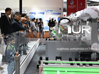 Visitors visit the NACHI exhibition area during the technical equipment exhibition area of the 7th China International Import Expo in Shangh...