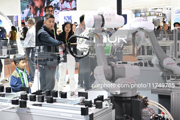 Visitors visit the NACHI exhibition area during the technical equipment exhibition area of the 7th China International Import Expo in Shangh...