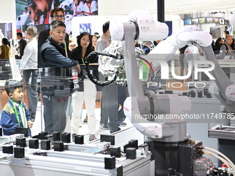 Visitors visit the NACHI exhibition area during the technical equipment exhibition area of the 7th China International Import Expo in Shangh...