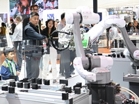 Visitors visit the NACHI exhibition area during the technical equipment exhibition area of the 7th China International Import Expo in Shangh...