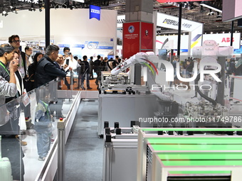 Visitors visit the NACHI exhibition area during the technical equipment exhibition area of the 7th China International Import Expo in Shangh...