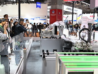 Visitors visit the NACHI exhibition area during the technical equipment exhibition area of the 7th China International Import Expo in Shangh...