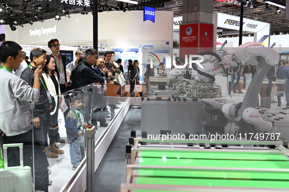 Visitors visit the NACHI exhibition area during the technical equipment exhibition area of the 7th China International Import Expo in Shangh...