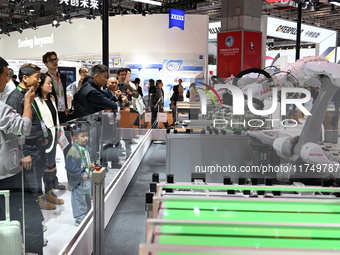 Visitors visit the NACHI exhibition area during the technical equipment exhibition area of the 7th China International Import Expo in Shangh...