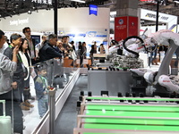 Visitors visit the NACHI exhibition area during the technical equipment exhibition area of the 7th China International Import Expo in Shangh...