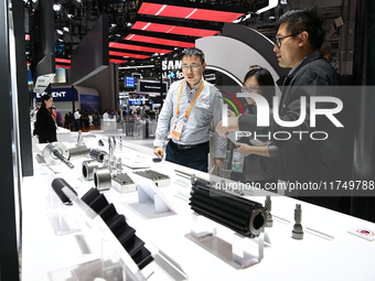 Visitors visit the NACHI exhibition area during the technical equipment exhibition area of the 7th China International Import Expo in Shangh...