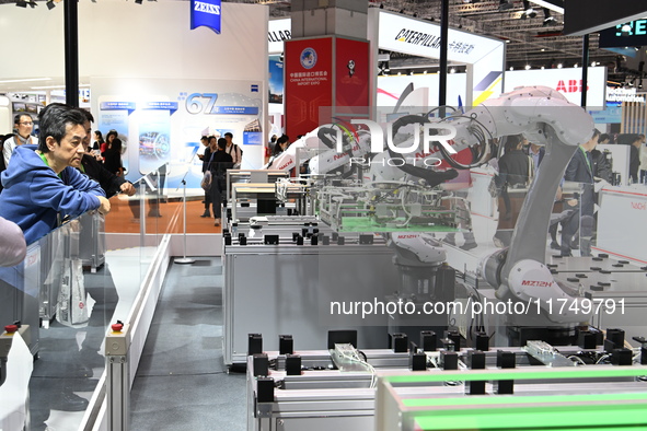 Visitors visit the NACHI exhibition area during the technical equipment exhibition area of the 7th China International Import Expo in Shangh...