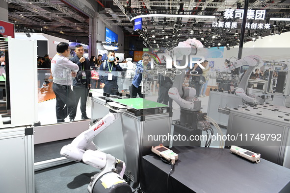 Visitors visit the NACHI exhibition area during the technical equipment exhibition area of the 7th China International Import Expo in Shangh...