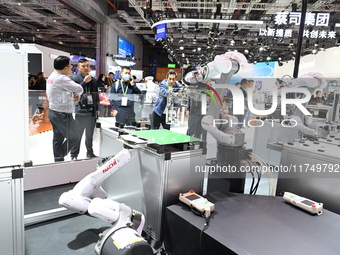 Visitors visit the NACHI exhibition area during the technical equipment exhibition area of the 7th China International Import Expo in Shangh...