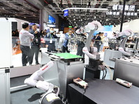 Visitors visit the NACHI exhibition area during the technical equipment exhibition area of the 7th China International Import Expo in Shangh...