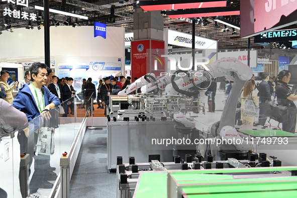 Visitors visit the NACHI exhibition area during the technical equipment exhibition area of the 7th China International Import Expo in Shangh...