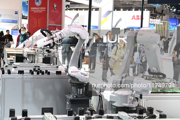 Visitors visit the NACHI exhibition area during the technical equipment exhibition area of the 7th China International Import Expo in Shangh...