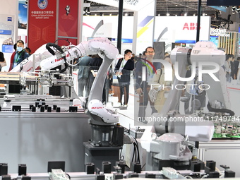 Visitors visit the NACHI exhibition area during the technical equipment exhibition area of the 7th China International Import Expo in Shangh...