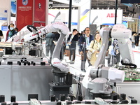 Visitors visit the NACHI exhibition area during the technical equipment exhibition area of the 7th China International Import Expo in Shangh...