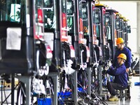 Workers assemble a cab at a loader manufacturing enterprise at Yunmenshan Street in Qingzhou, China, on October 31, 2024. On the same day, t...