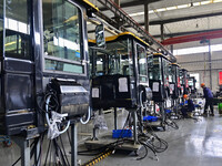 Workers assemble a cab at a loader manufacturing enterprise at Yunmenshan Street in Qingzhou, China, on October 31, 2024. On the same day, t...