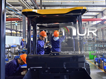 Workers assemble a cab at a loader manufacturing enterprise at Yunmenshan Street in Qingzhou, China, on October 31, 2024. On the same day, t...