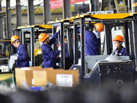 Workers assemble a cab at a loader manufacturing enterprise at Yunmenshan Street in Qingzhou, China, on October 31, 2024. On the same day, t...