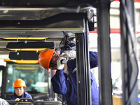 Workers assemble a cab at a loader manufacturing enterprise at Yunmenshan Street in Qingzhou, China, on October 31, 2024. On the same day, t...