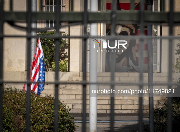 The U.S. flag hangs upside down next to an anti-U.S. mural at the former U.S. embassy in Tehran, Iran, on November 7, 2024. Former U.S. Pres...