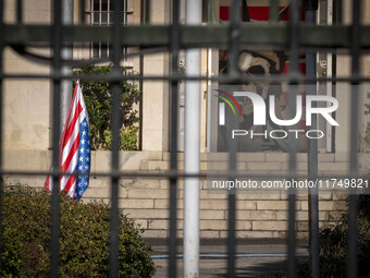 The U.S. flag hangs upside down next to an anti-U.S. mural at the former U.S. embassy in Tehran, Iran, on November 7, 2024. Former U.S. Pres...