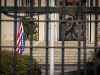 The U.S. flag hangs upside down next to an anti-U.S. mural at the former U.S. embassy in Tehran, Iran, on November 7, 2024. Former U.S. Pres...