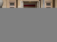 An Iranian family walks past the U.S. flag, which hangs upside down, while visiting the former U.S. embassy in Tehran, Iran, on November 7,...